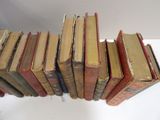a lot of old books stacked on top of each other