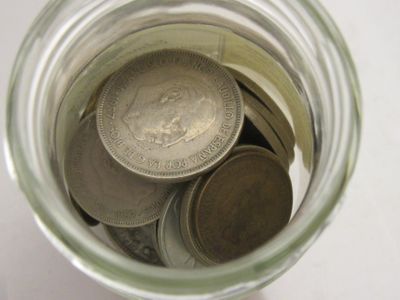 a jar full of coins sitting on a table