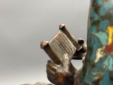 a statue of a person holding a book in their hand