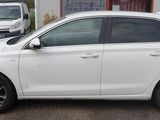 a white car that is parked in front of a building
