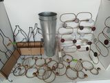 a metal vase and a bunch of wine glasses on a table