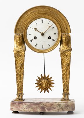 Une pendule portique en bronze doré à cadran émail blanc, in…