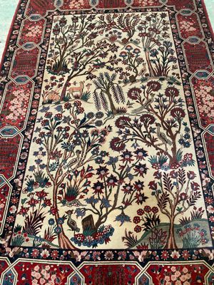 an oriental rug with a tree of life design on it