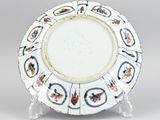 an image of a white plate with blue and orange designs on it