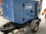 a trailer with a blue generator on it in a warehouse