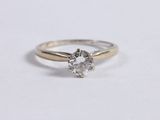 a close up of a diamond ring on a white surface