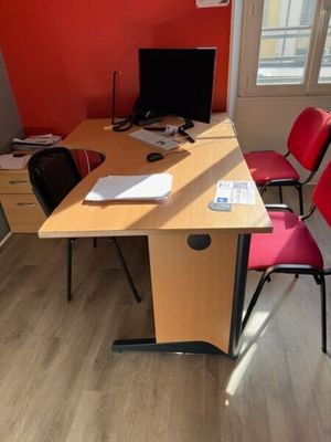 a desk with two chairs and a computer on top of it