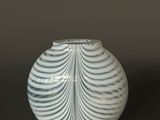 a white vase that is sitting on a table