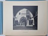 an old photo of an old building in the middle of the picture