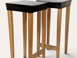 two wooden tables with black tops and legs on a white background