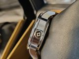 a close up of a watch on a wrist in a box