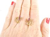an image of a woman ' s hand with two rings on it