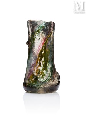 a glass vase that is sitting on a white surface