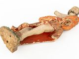 a figurine of a man laying down on the ground