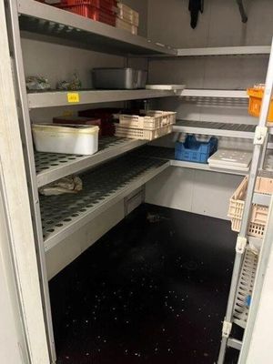 a pantry with many shelves and bins of food