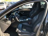 the interior of a car with the door open and the driver ' s seat up