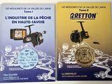 two books about fishing and fishing equipment on a table