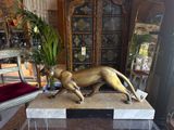 a statue of a cat on a table in a living room