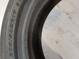 a close up of a tire on a table with a piece of paper