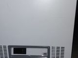 an image of a small white refrigerator in a room