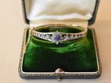 an image of a diamond and sapphire ring in a box