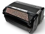 a black accordion sitting on top of a white surface