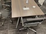 an image of a conference table and chairs in a conference room