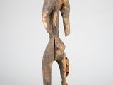 an old wooden statue of a man holding a piece of wood