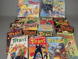 many comics are stacked on top of each other on a table