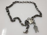 a chain with a padlock and two keys attached to it