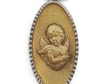 a gold medal with an image of an angel holding a baby