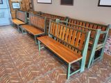 three wooden benches sitting next to each other in a room
