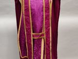 a close up of a purple vest on a mannequin stand