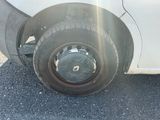 a white car that has a flat tire on the road