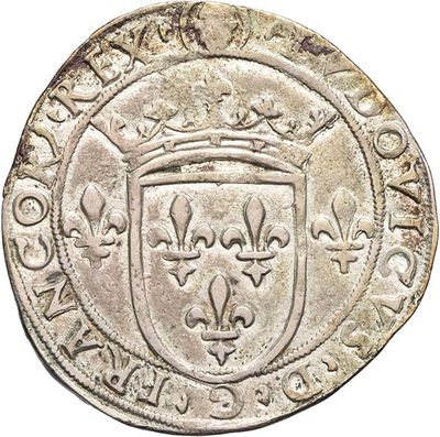 an old silver coin with a shield on it