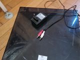 a laptop computer sitting on the floor with a pair of glasses on top of it