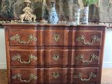 a dresser that has a vase on top of it