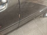 a close up of a car ' s door and side of the car