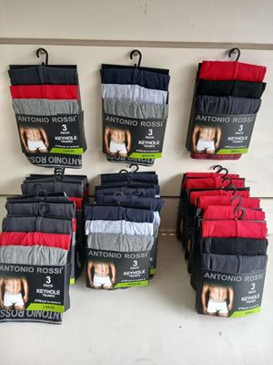 six pairs of men ' s boxer briefs are displayed on a shelf