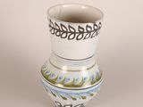 a white vase with a blue and green design on it