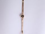 an image of a gold watch with a black face on a white surface