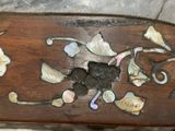 a close up of a wooden bench with shells and shells on it