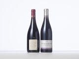 two bottles of wine sit side by side on a table