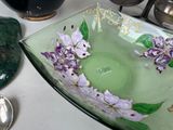 a glass bowl with flowers painted on it