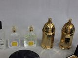 a lot of perfume bottles and other items sitting on a table