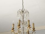 chandelier in the dining room of a house with a white ceiling