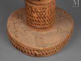 a statue of a man with a hat on a pedestal