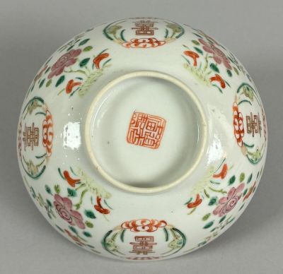 a white bowl with a red and green design on it