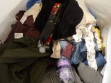 a pile of clothes and clothes in a white box