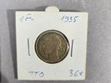 a close up of a small coin on a white surface